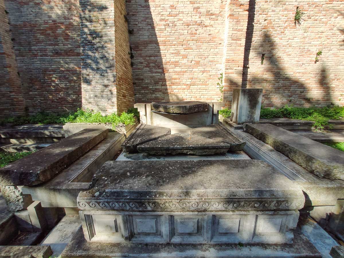 resti in pietra della prima tomba di Giacomo Leopardi ricomposti contro le mura del parco del Colle dell'Infinito